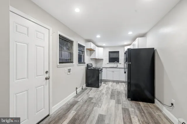 a view of a room with wooden floor and a hallway