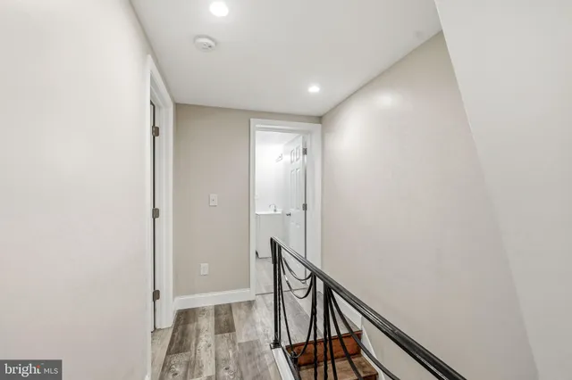 a view of empty room with wooden floor and window