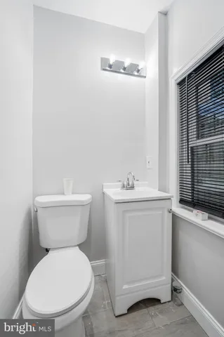 a white toilet sitting next to a bathroom sink