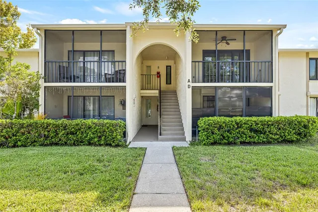 a view of a house with pool yard and sitting area