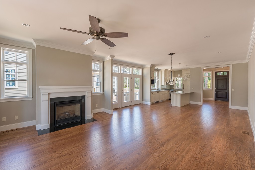 40 Clayton Circle, Unit A Mashpee, MA 02649 - Photo 7 of 12 a view of an empty room with wooden floor fireplace and a window