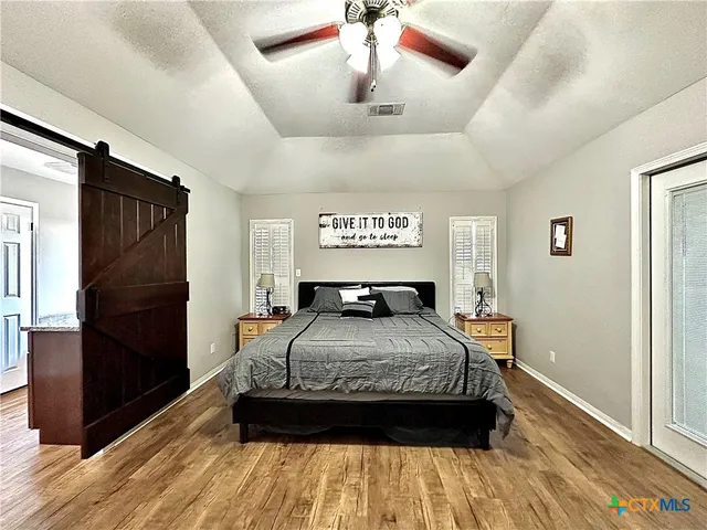 a bedroom with a bed and wooden floor