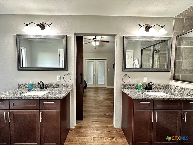 a bathroom with a double vanity sink and mirror