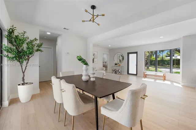 a view of a dining room with furniture and a potted plant