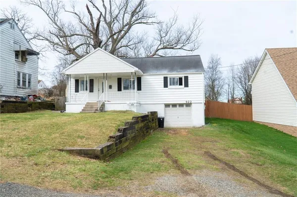 a front view of a house with yard and mountain view
