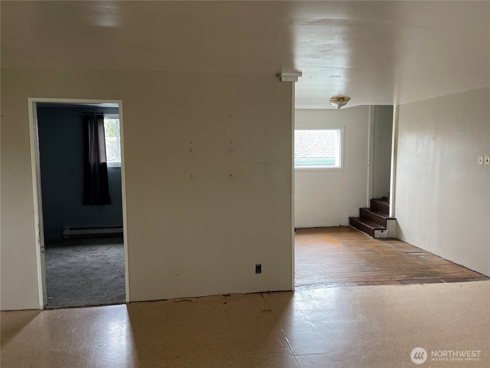 606 West Schley Street Aberdeen, WA 98520 - Photo 10 of 19 an empty room with wooden floor and windows