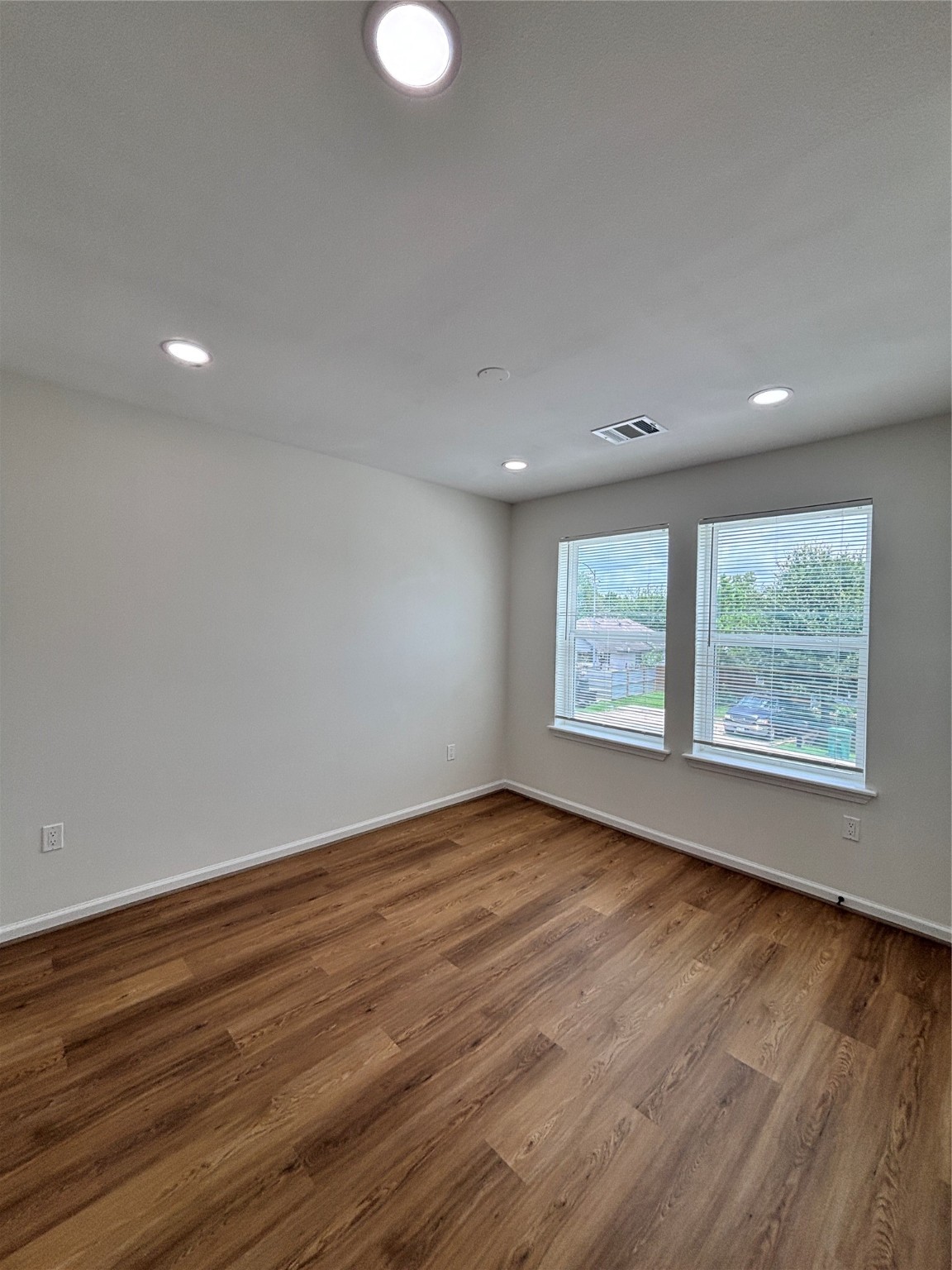 9913 Porto Rico Road, Unit B Houston, TX 77041 - Photo 13 of 26 a view of an empty room with wooden floor and a window