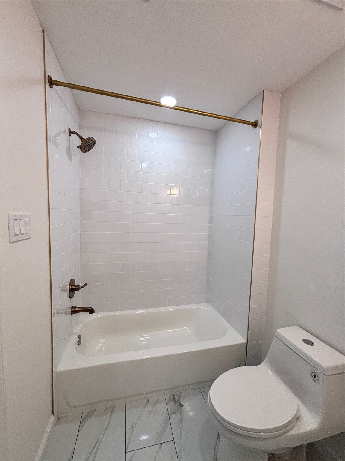 9913 Porto Rico Road, Unit B Houston, TX 77041 - Photo 16 of 26 a bathroom with a toilet and a bath tub