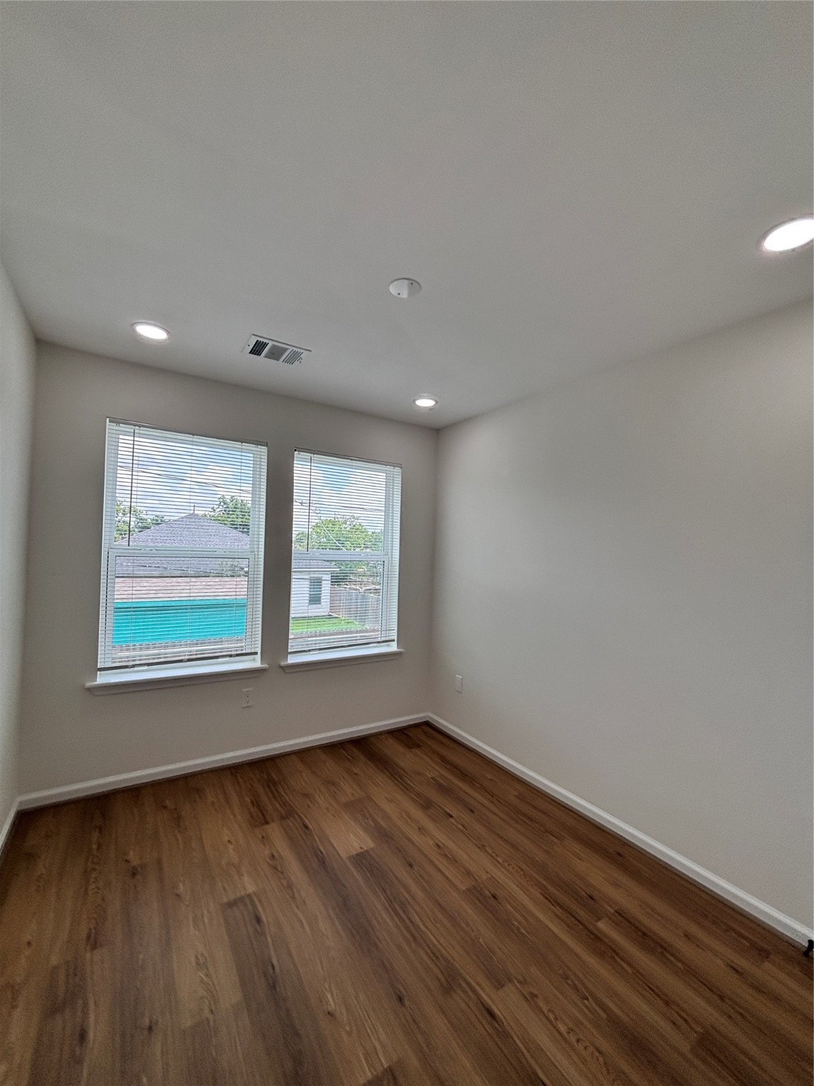 9913 Porto Rico Road, Unit B Houston, TX 77041 - Photo 21 of 26 a view of an empty room with wooden floor and a window