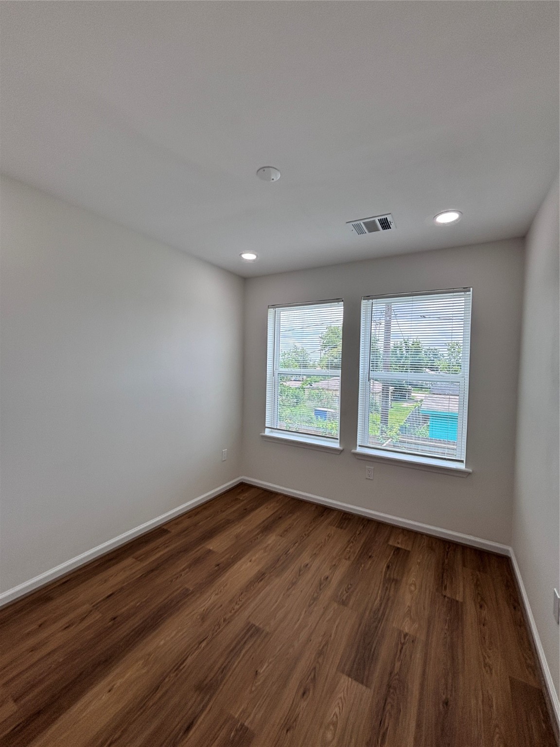 9913 Porto Rico Road, Unit B Houston, TX 77041 - Photo 23 of 26 an empty room with wooden floor and windows