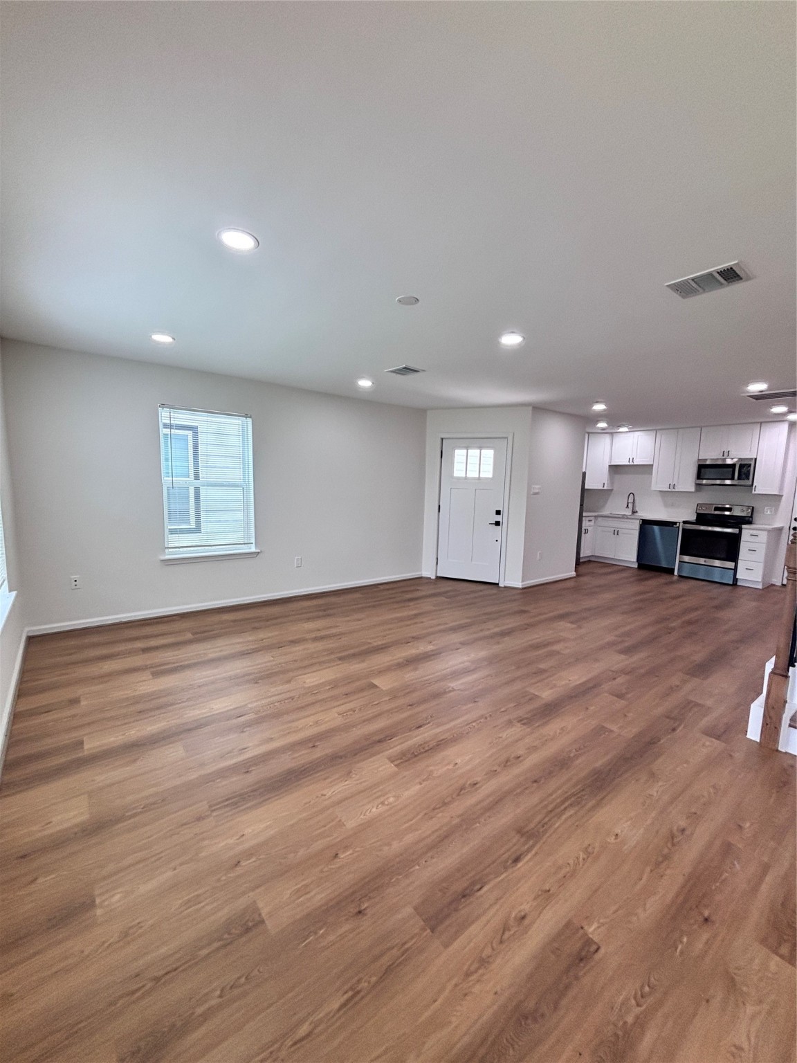 9913 Porto Rico Road, Unit B Houston, TX 77041 - Photo 3 of 26 a view of a big room with wooden floor and windows