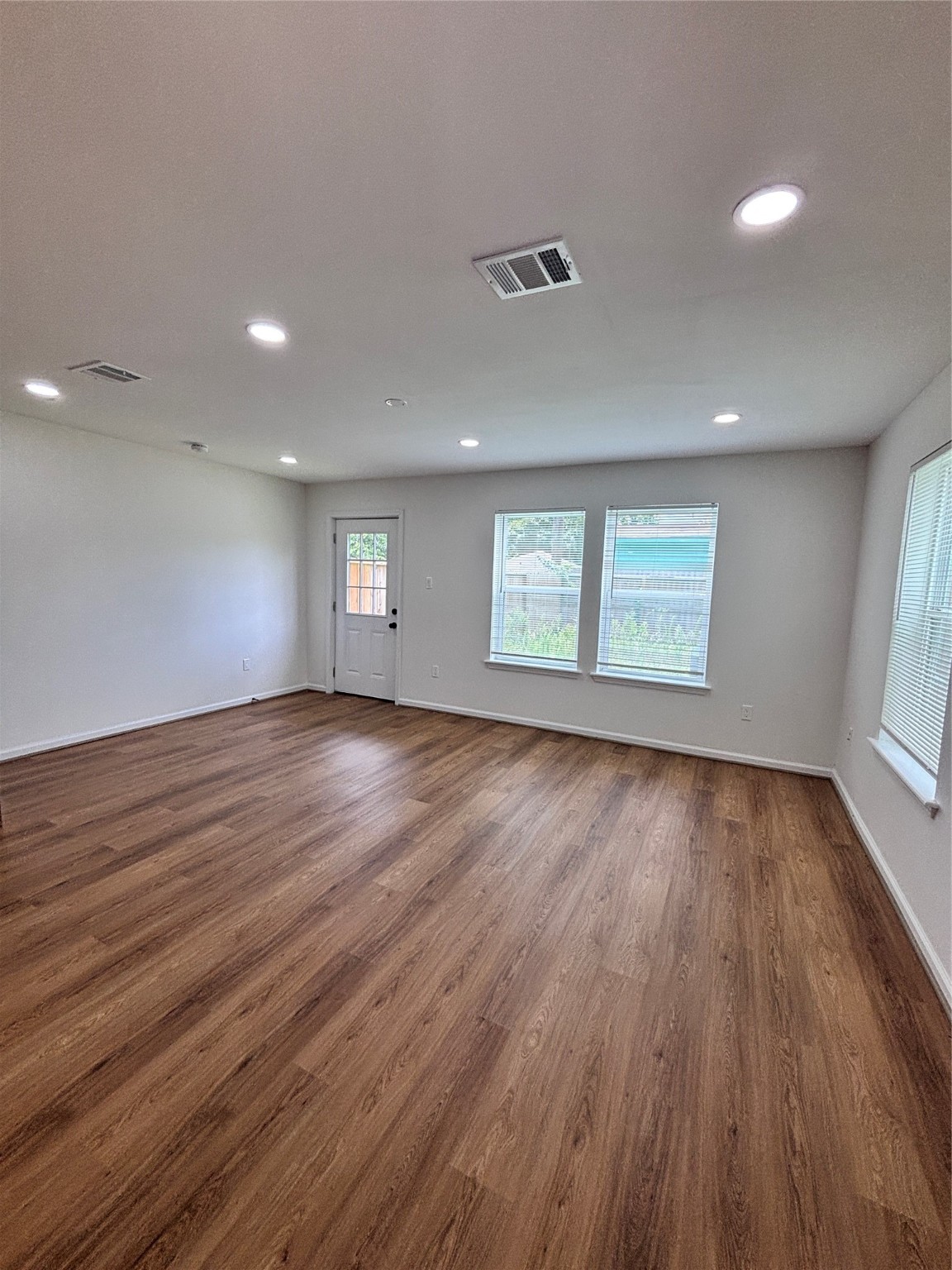 9913 Porto Rico Road, Unit B Houston, TX 77041 - Photo 4 of 26 an empty room with wooden floor and windows