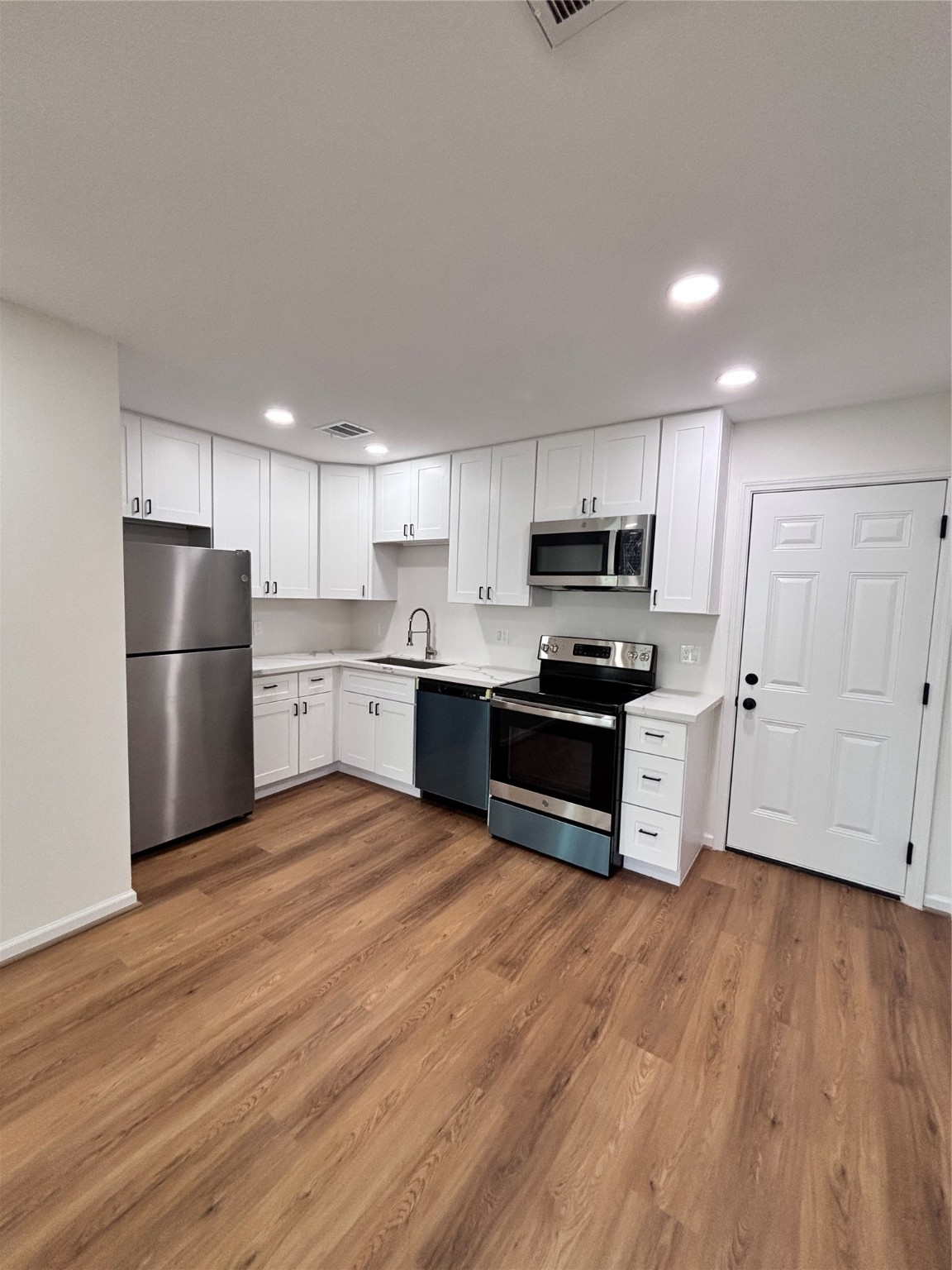 9913 Porto Rico Road, Unit B Houston, TX 77041 - Photo 5 of 26 a kitchen with granite countertop a refrigerator and a stove top oven