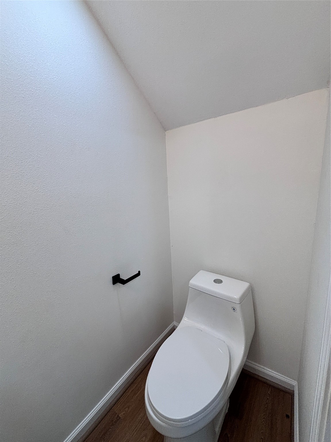 9913 Porto Rico Road, Unit B Houston, TX 77041 - Photo 9 of 26 a white toilet sitting next to a white wall