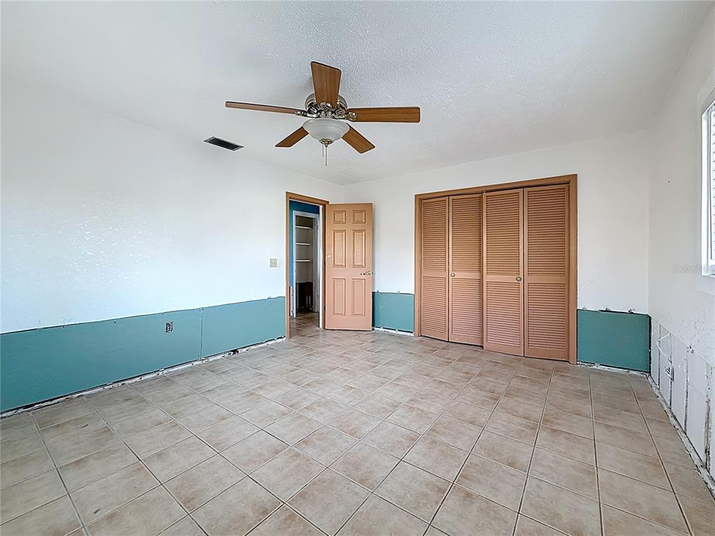 4869 Shell Stream Boulevard New Port Richey, FL 34652 - Photo 28 of 46 an empty room with closet and windows