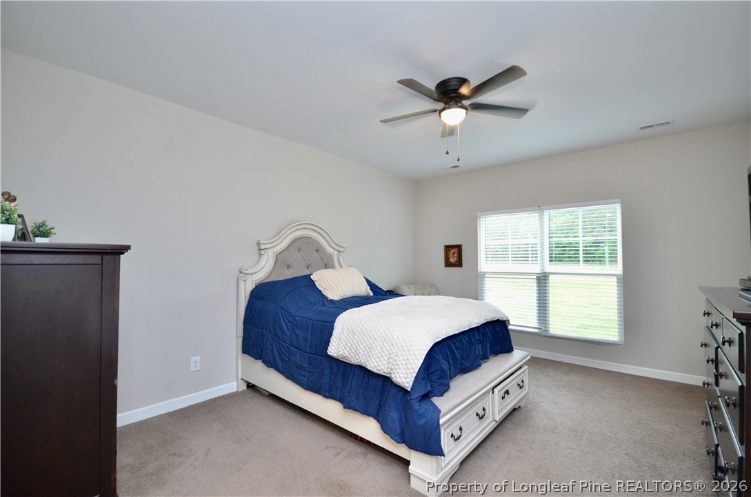 1865 John B Carter Road Fayetteville, NC 28312 - Photo 16 of 49 a bedroom with a bed and window
