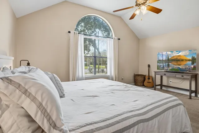 a bedroom with a bed and a window