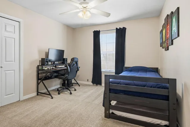a bedroom with a bed and flat screen tv