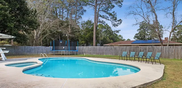 a view of a house with swimming pool and sitting area