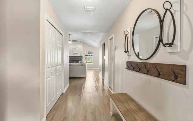a view of a hallway with wooden floor