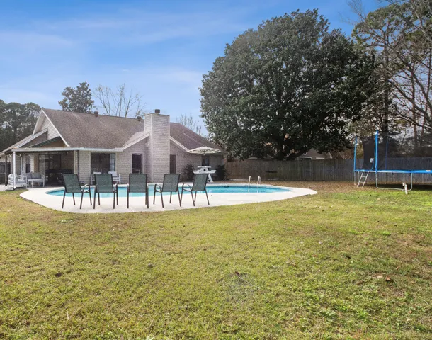 a view of a house with swimming pool and sitting area