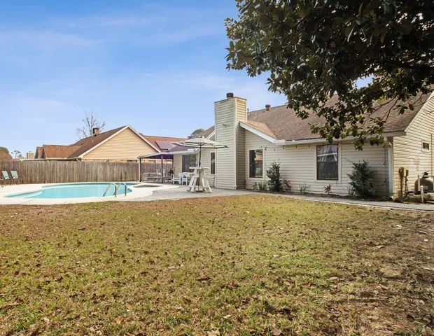 a view of a swimming pool with an outdoor space and seating area