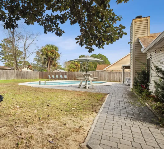 a view of a backyard with a large tree