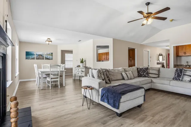 a living room with furniture wooden floor and a chandelier