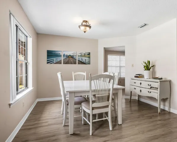a dining room with furniture and wooden floor