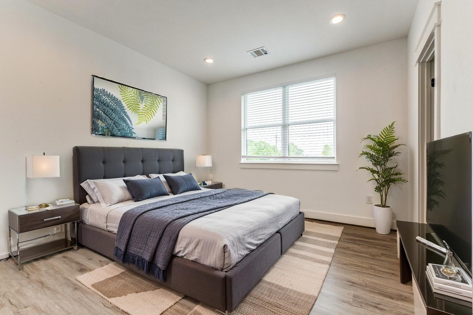 728 East 38th Street Houston, TX 77022 - Photo 11 of 18 Spacious secondary bedrooms featue LVP flooring and a walk-in closets for added comfort and storage. *virtually staged*