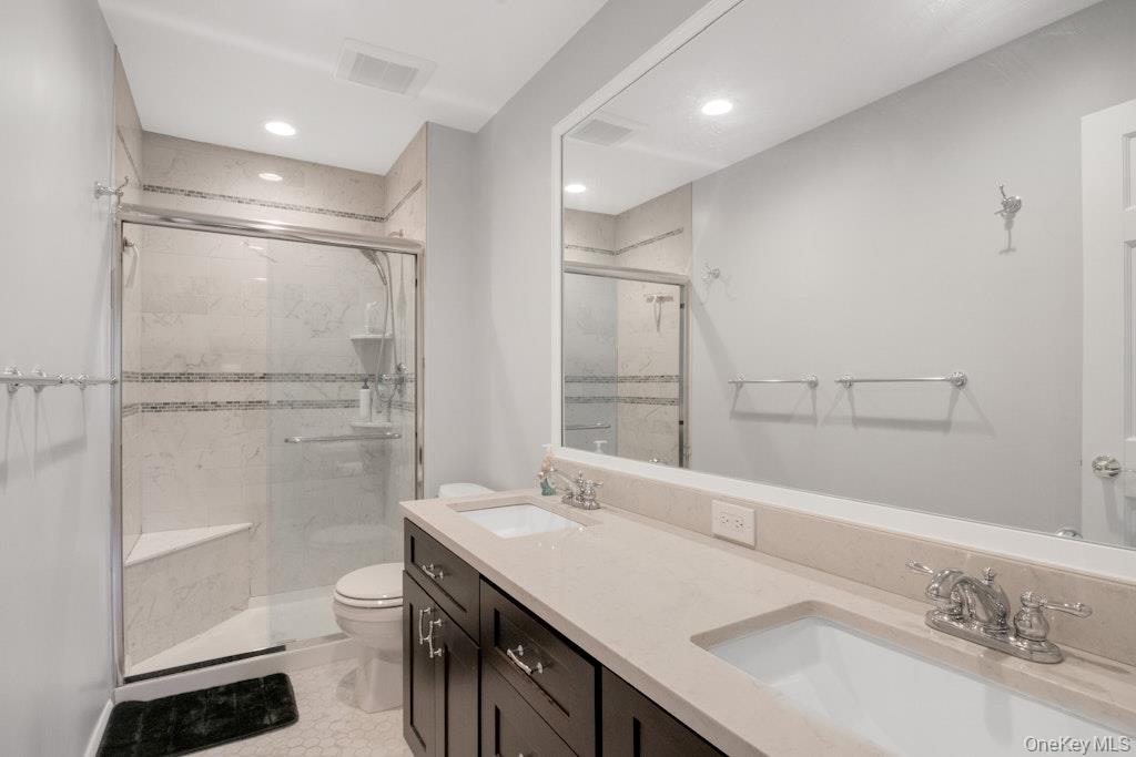 34 Jackson Road Briarcliff Manor, NY 10510 - Photo 18 of 29 a bathroom with a sink toilet a mirror and shower