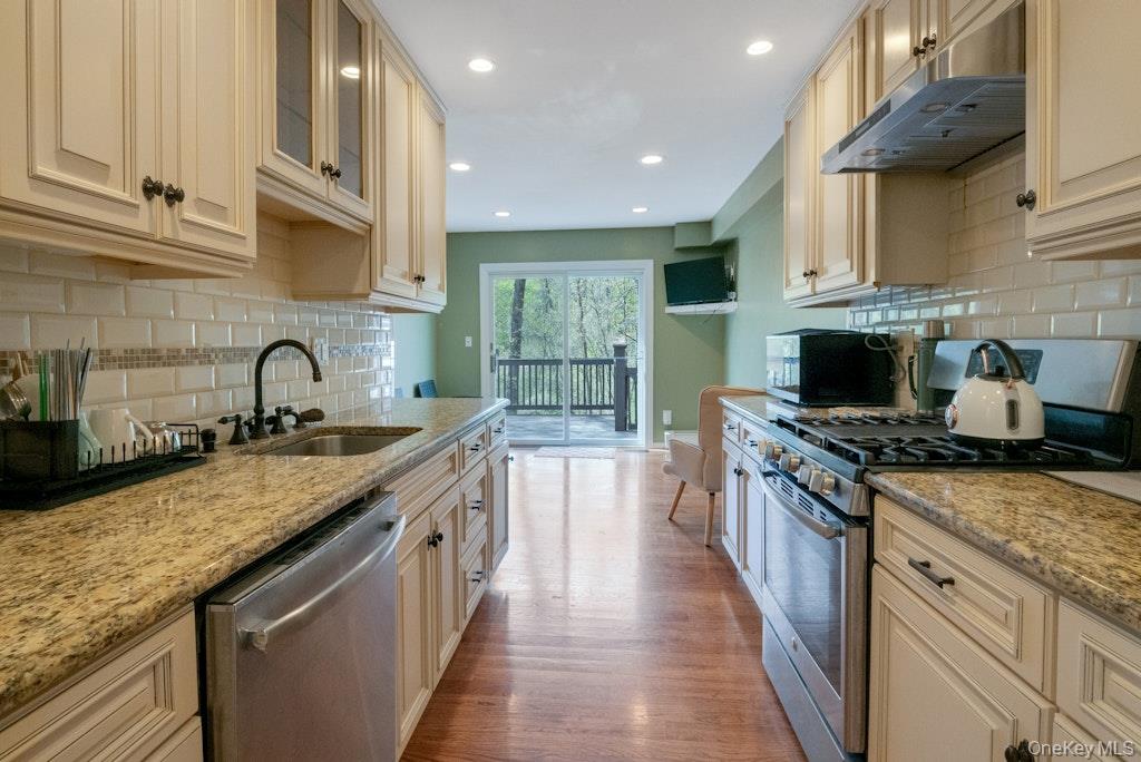 34 Jackson Road Briarcliff Manor, NY 10510 - Photo 4 of 29 a kitchen with granite countertop a sink stove and cabinets