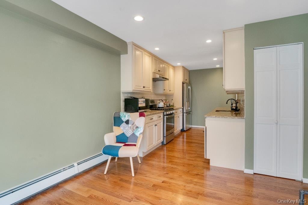 34 Jackson Road Briarcliff Manor, NY 10510 - Photo 5 of 29 a kitchen with stainless steel appliances a refrigerator and wooden floor