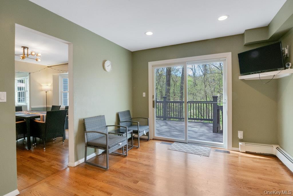 34 Jackson Road Briarcliff Manor, NY 10510 - Photo 7 of 29 a living room with furniture a flat screen tv and floor to ceiling window
