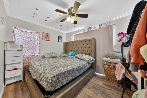 a kitchen with stainless steel appliances a refrigerator and a wooden floor