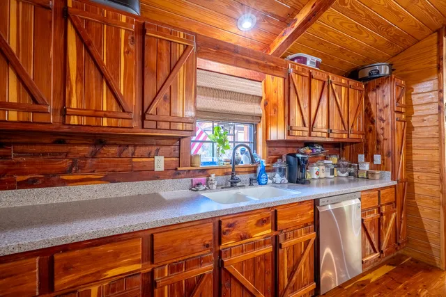 a kitchen with stainless steel appliances a sink and cabinets