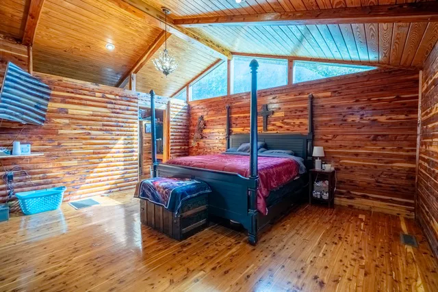 a bedroom with a bed and a ceiling fan