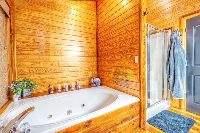 a bathroom with a tub and shower