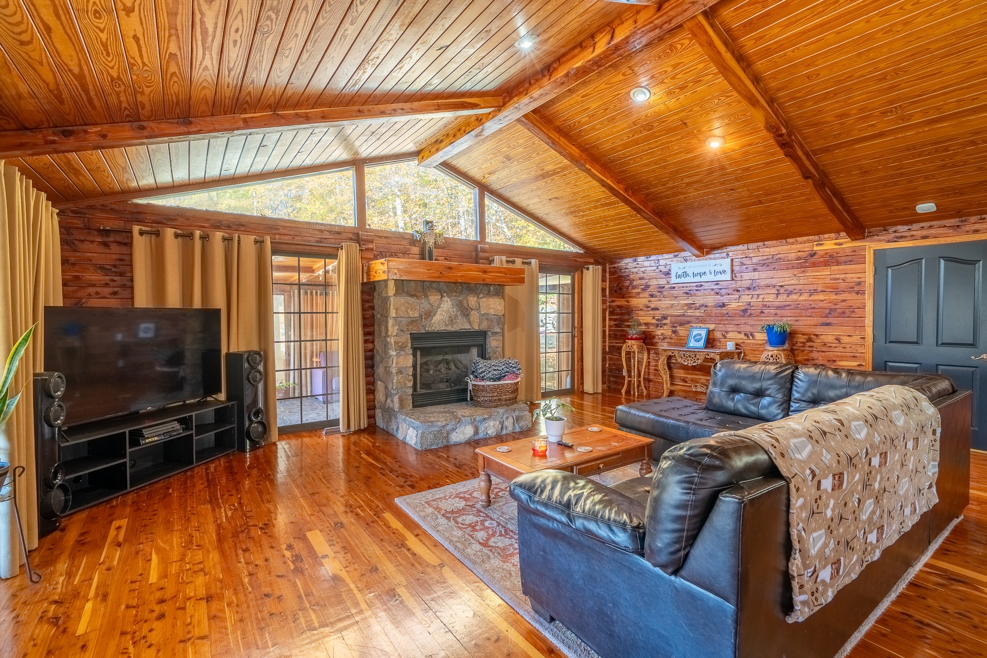 999 Rainbow Lake Road Waynesboro, TN 38485 - Photo 6 of 44 a living room with furniture a flat screen tv and floor to ceiling window