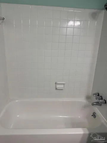 a bathroom with a shower and a bath tub
