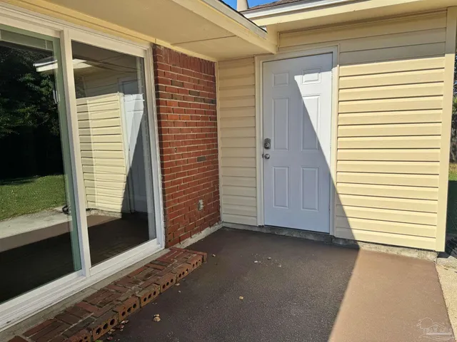 a view of a house with a door and wooden walls