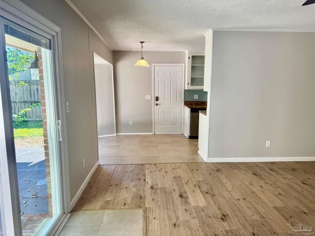 a view of a hallway with wooden shelves and entryway