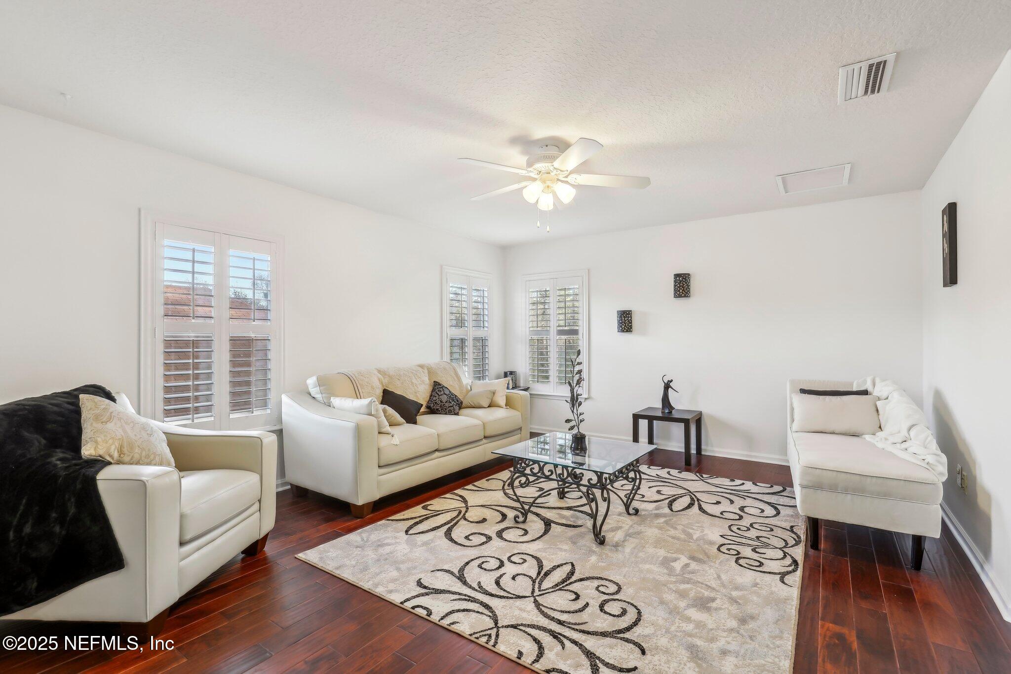 216 Brantley Harbor Drive St. Augustine, FL 32086 - Photo 14 of 33 a living room with furniture wooden floor and a table