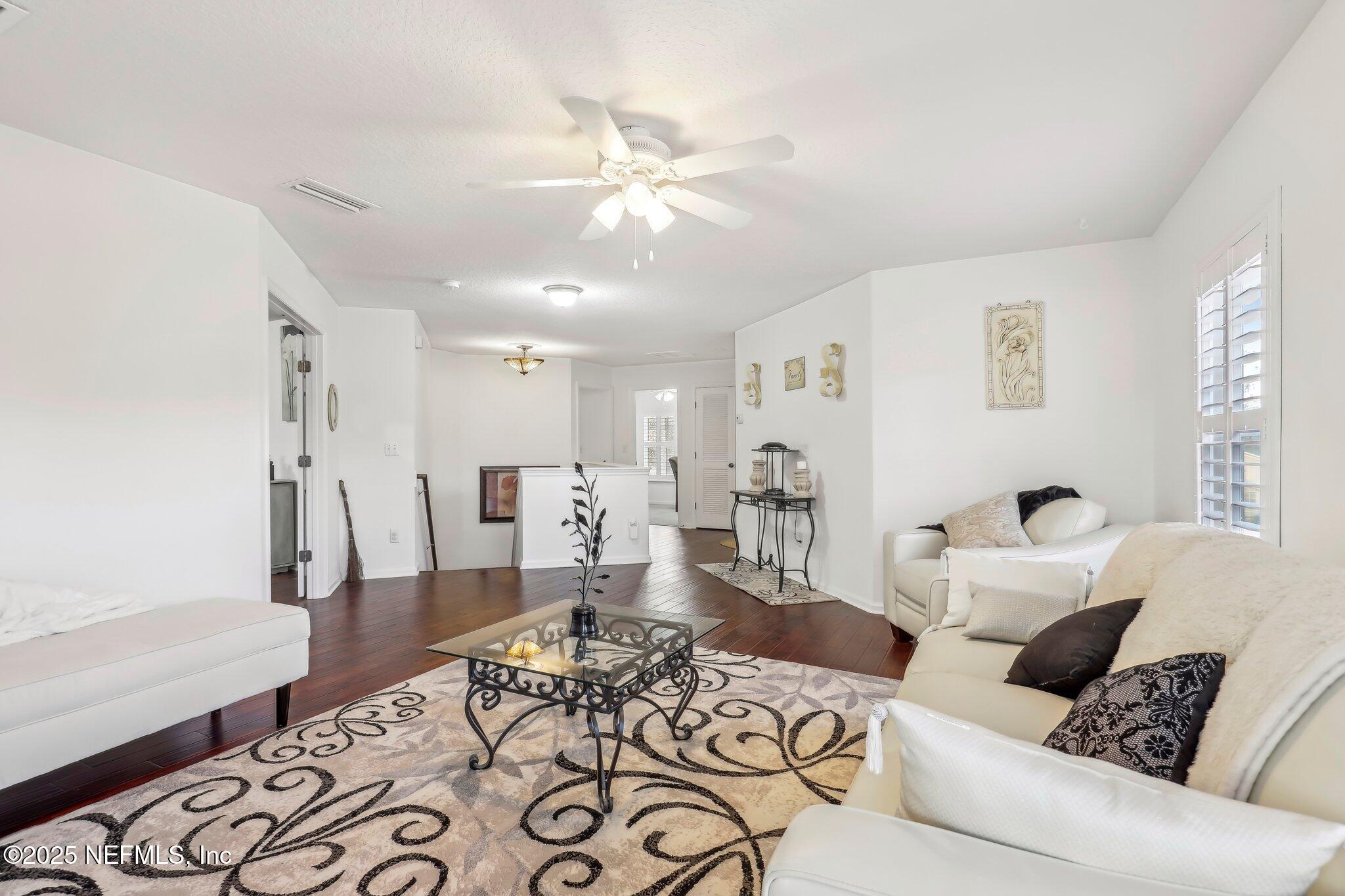 216 Brantley Harbor Drive St. Augustine, FL 32086 - Photo 16 of 33 a living room with furniture and a chandelier