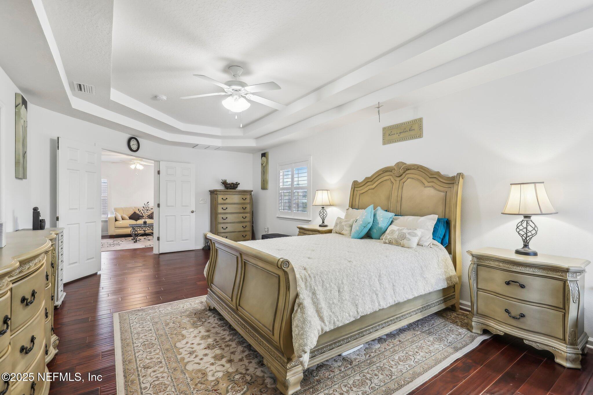 216 Brantley Harbor Drive St. Augustine, FL 32086 - Photo 22 of 33 a bedroom with a bed and wooden floor