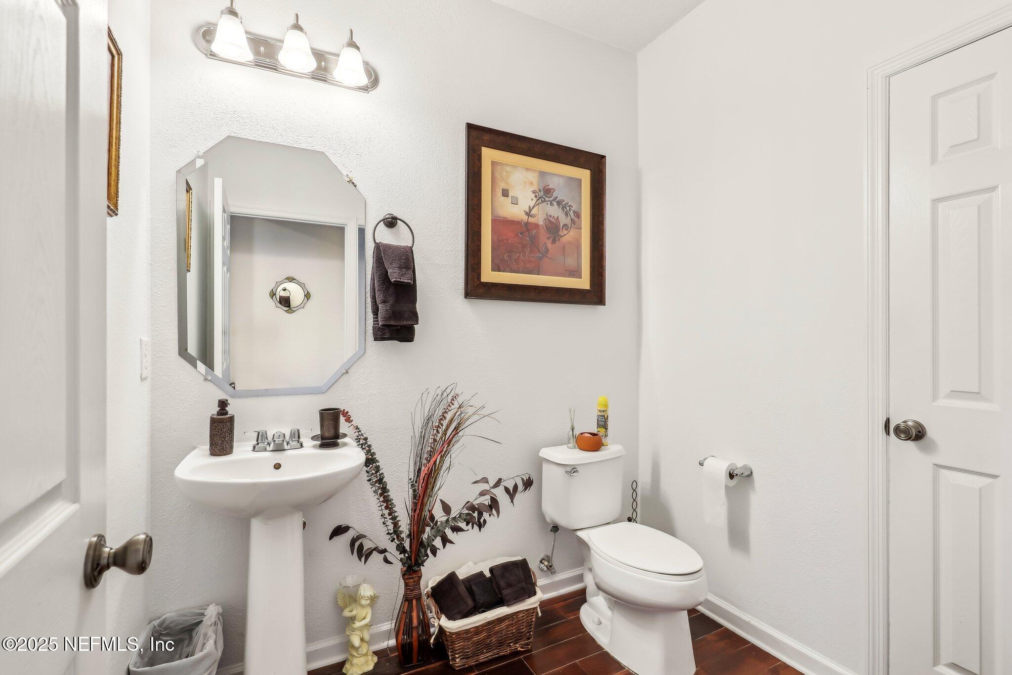 216 Brantley Harbor Drive St. Augustine, FL 32086 - Photo 24 of 33 a bathroom with a toilet sink and mirror