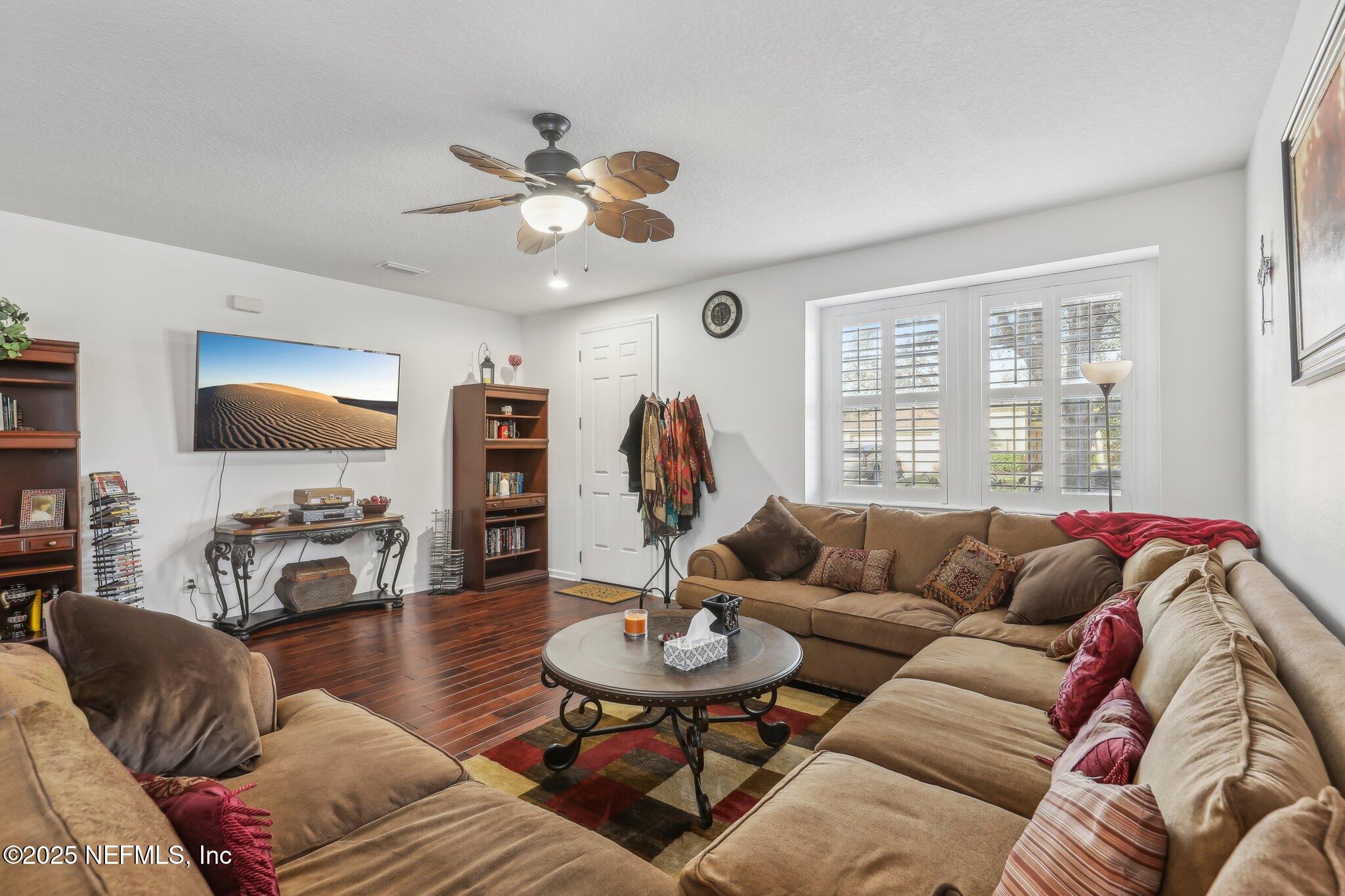 216 Brantley Harbor Drive St. Augustine, FL 32086 - Photo 6 of 33 a living room with furniture a flat screen tv and a large window
