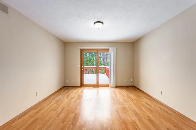 a view of a room with wooden floor and iron stairs