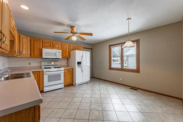 a kitchen with a stove a sink and a refrigerator