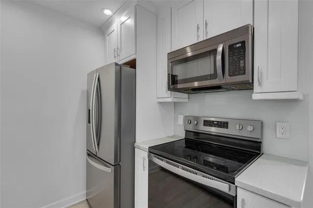 a kitchen with a stove microwave and sink